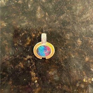 Opal pendant set in 14kt gold with diamond accents.